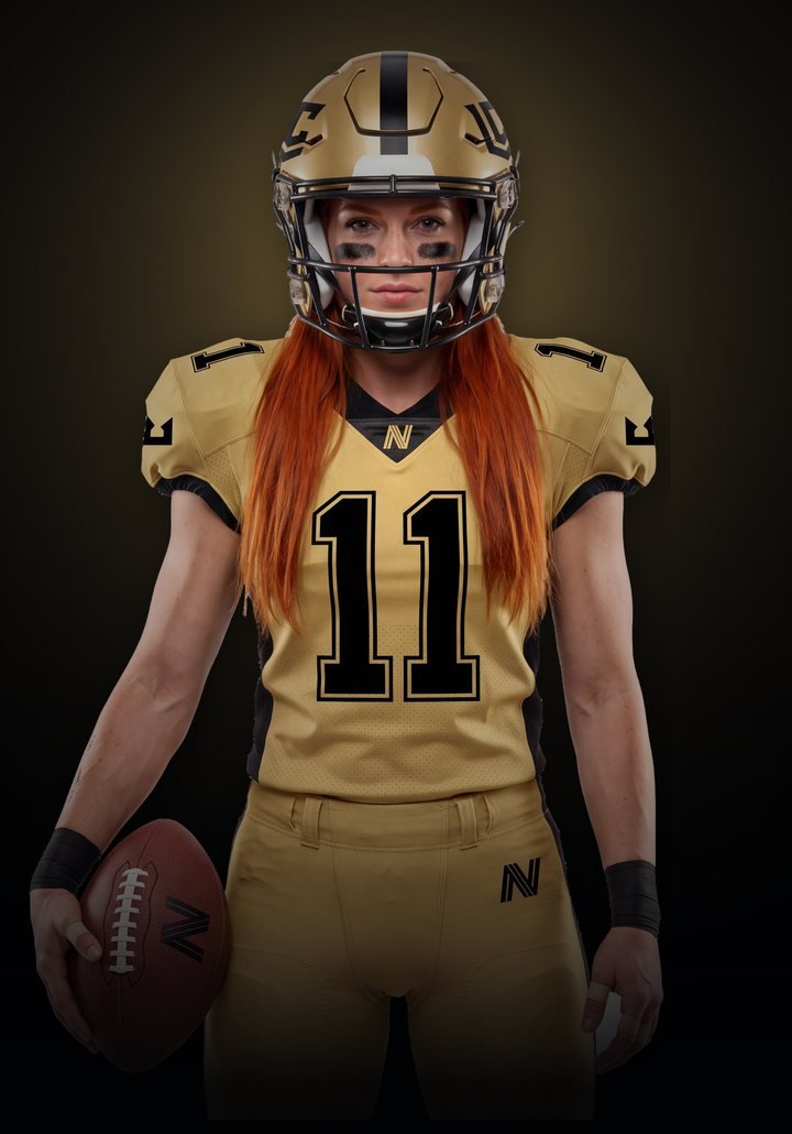 Los Angeles Crown athlete in a gold number 11 jersey holding a football